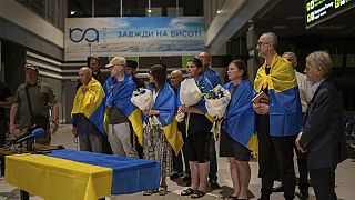 Nariman Dzhelyal, second right, deputy head of the Mejlis of the Crimean Tatar People stands among with other prisoners who have been recently released in Kyiv airport, 06/24.