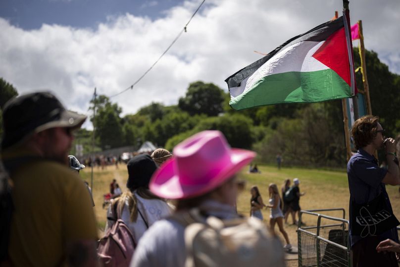 Glastonbury festival goes walk by a Palestinian flag at Worthy Farm in Somerset, June 27, 2024