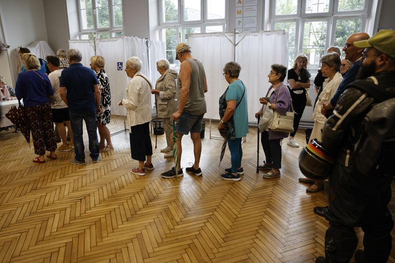 People queue to vote in Strasbourg, eastern France, Sunday, June 30, 2024. 