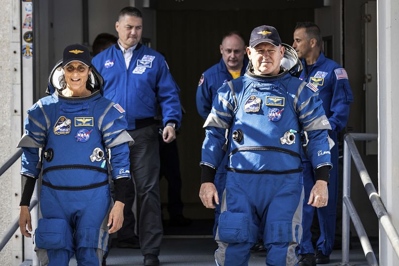 NASA's Boeing Crew Flight Test astronauts Suni Williams and Butch Wilmore exit the Neil A. Armstrong Operations and Checkout Building at the agency's Kennedy Space Center 