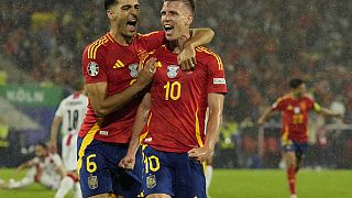 Spain's Dani Olmo, right, celebrates after scoring his side's 4th goal against Georgia during a round of sixteen match at the Euro 2024 soccer tournament in Cologn