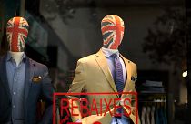 Mannequin with their heads decorated with Great Britain's union flag display fashion designers clothes in a tailoring shop in Barcelona, 25 June 2016