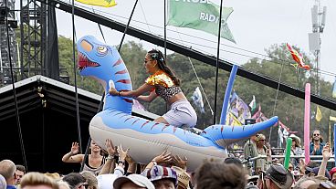 A festival goer rides an inflatable across the audience at the Shania Twain performance during the Glastonbury Festival in Worthy Farm, Somerset, England, June 30, 2024
