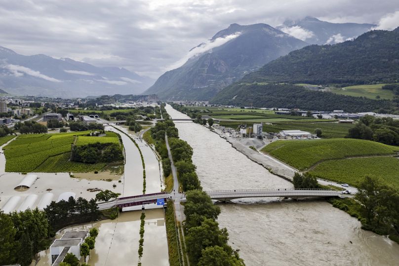 The Rhone River is overflowing the A9 motorway following the storms that caused major flooding, in Sierre, Switzerland, Sunday, June 30, 2024.