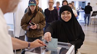 A woman votes in Strasbourg, eastern France, Sunday, June 30, 2024. 