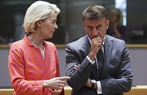 French President Emmanuel Macron, right, speaks with European Commission President Ursula von der Leyen during a round table meeting at an EU summit in Brussels, Thursday, Jun