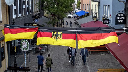 German national flags decorate the party hot spot Alt Sachsenhausen in Frankfurt, Germany, Thursday, June 13, 2024, the day before the start of the Euro 2024 soccer tournament