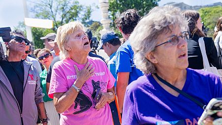 Celeste McCall, left, of Washington, reacts in confusion, Monday, July 1, 2024, outside the Supreme Court in Washington. 
