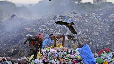 Waste pickers Salmaa and Usmaan Shekh, right, search for recyclable materials during a heat wave at a garbage dump on the outskirts of Jammu, India
