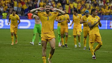 Romania's Radu Dragusin celebrates at the end of Group E match at the Euro 2024 football tournament against Slovakia in Frankfurt, Germany, Wednesday, June 26, 2024