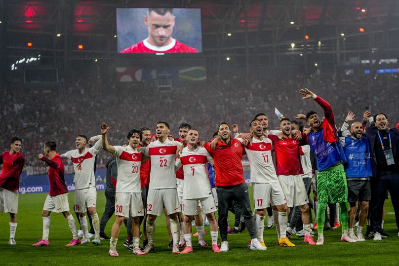 Turkish players celebrate qualifying for the Euro 2024 quarter-finals after beating Austria 2-1
