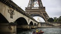 Un barco navega por el río Sena cerca de la Torre Eiffel durante un ensayo para la ceremonia de los Juegos Olímpicos de París 2024, junio de 2024 en París.