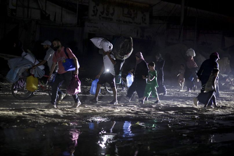 Palestinians flee Khan Younis neighborhoods following an evacuation order issued by the Israeli army, Monday July 1, 2024.