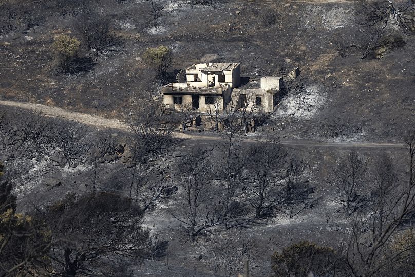 A destroyed home is seen amidst a burnt area after a wildfire at Keratea area, southeast of Athens, Greece, Sunday, 30 June 2024.