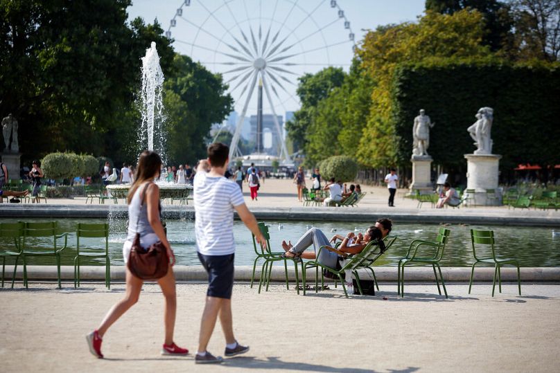 People stroll through the iconic Tuileries Gardens in Paris
