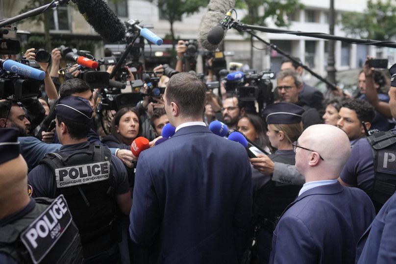 Jordan Bardella, president of the far-right National Rally party, answers reporters as he arrives at the party headquarters, Monday, July 1, 2024 in Paris.