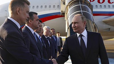 Russian President Vladimir Putin shakes hands with diplomats upon his arrival at the international airport in Astana, Kazakhstan, Wednesday, July 3, 2024.