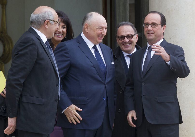 French President Francois Hollande bids farewell to President of the European Jewish Congress Moshe Kantor after a meeting at the Elysee Palace in Paris, July 2014