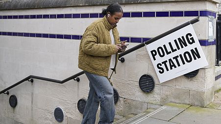 Eine Frau verlässt nach der Stimmabgabe in London ein Wahllokal