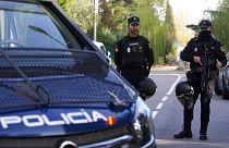 Police officers stand guard as they cordon off the area in Madrid, 30 November 2022