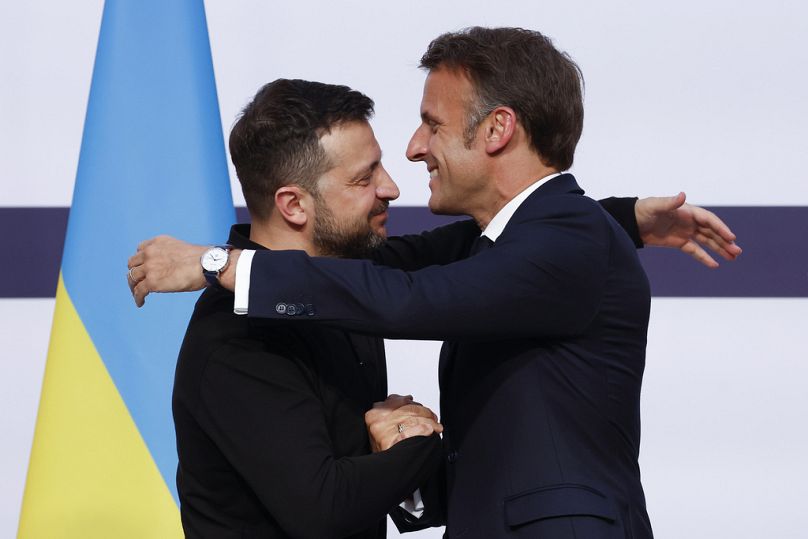 French President Emmanuel Macron, right, hugs Ukrainian President Volodymyr Zelenskyy during a joint press conference at the Elysee Palace in Paris, 7 June 2024
