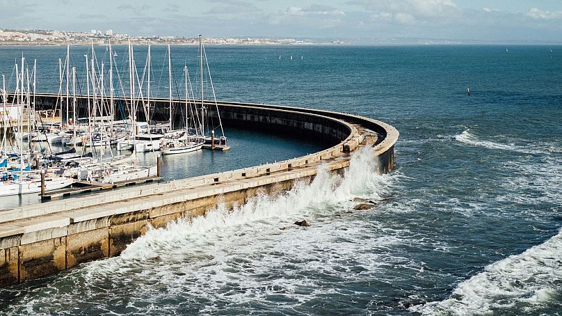 Waves crash against Lisbon harbour, Portugal. The city was almost completely destroyed by a tsunami in 1755.