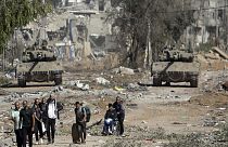 Palestinians flee to northern Gaza as Israeli tanks block the Salah al-Din road in the central Gaza Strip on Nov. 24, 2023
