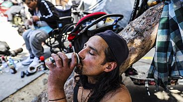 A homeless man named Angel drinks a soda to keep cool during a heat wave in San Francisco