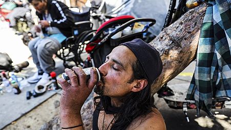 A homeless man named Angel drinks a soda to keep cool during a heat wave in San Francisco