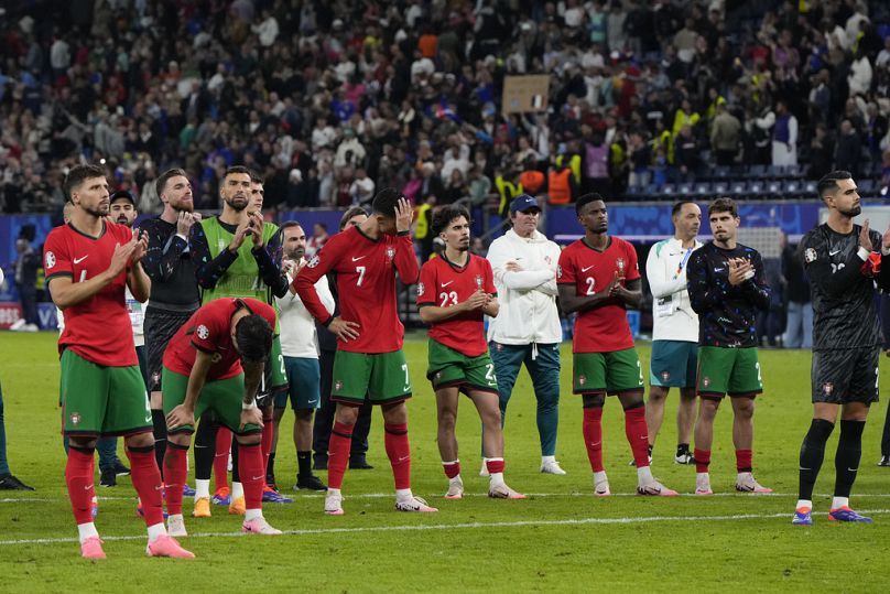 Portugal's team applaude their fans in Hamburg following their elimination against France