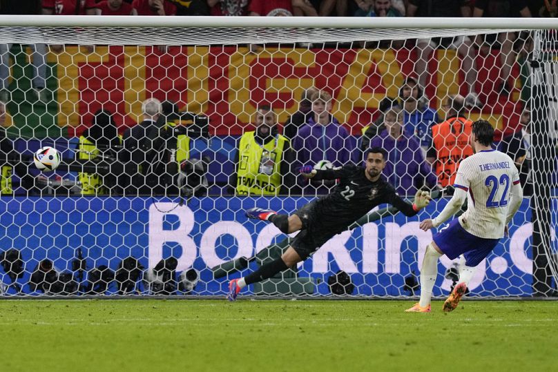France's Theo Hernandez scores the fifth and decisive penalty shootout