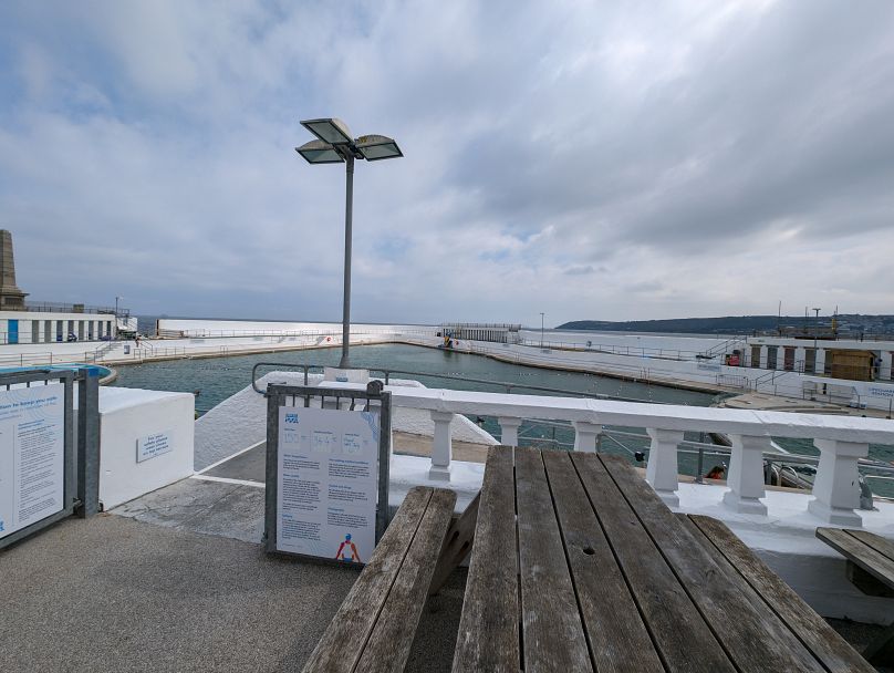 A sign shows the temperatures at the Jubilee Pool in Penzance.