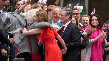 Britain's Labour Party Prime Minister Kier Starmer and his wife Victoria greet supporters as they arrive in Downing Street in London.