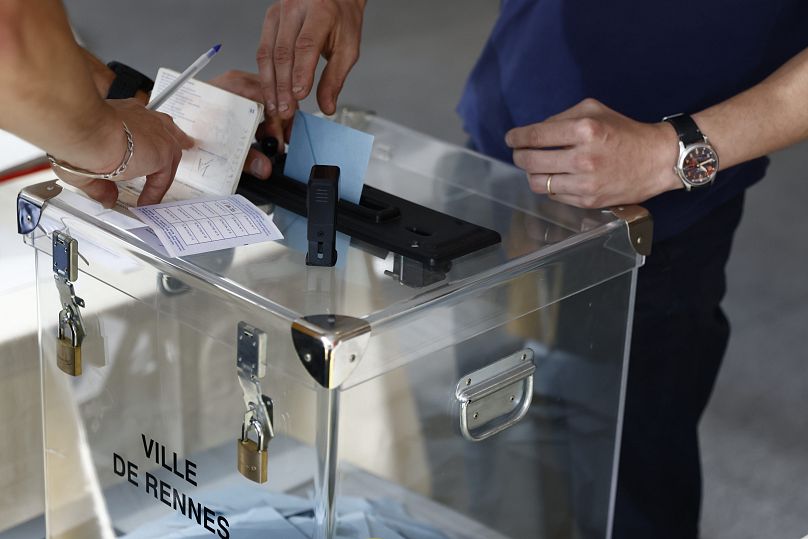 A voter casts a ballot at a polling station in Rennes, June 30, 2024