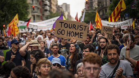Demonstrators march shouting slogans against the Formula 1 Barcelona Fan Festival in downtown Barcelona, Spain, Wednesday, June 19, 2024.