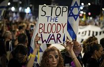 A demonstrator holds a sign during a protest marking nine months since the start of the war and calling for the release of hostages held in the Gaza.