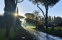 A man jogs on the ancient roman Appian Way in Rome