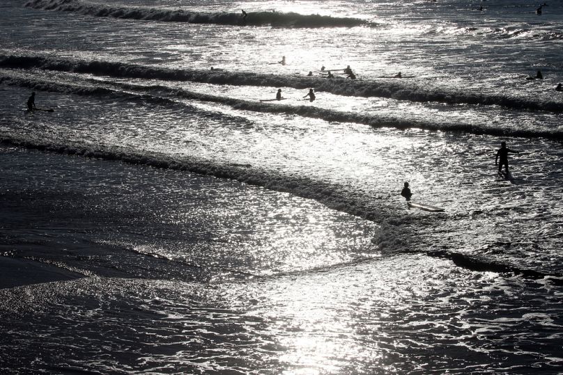 People swim in the Atlantic Ocean in Biarritz, October 2021