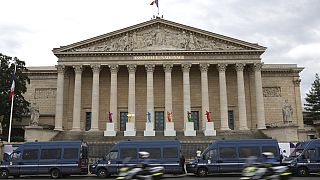 Police vans park outside the National Assembly during the second round of the legislative elections, Sunday, July 7, 2024 in Paris. 