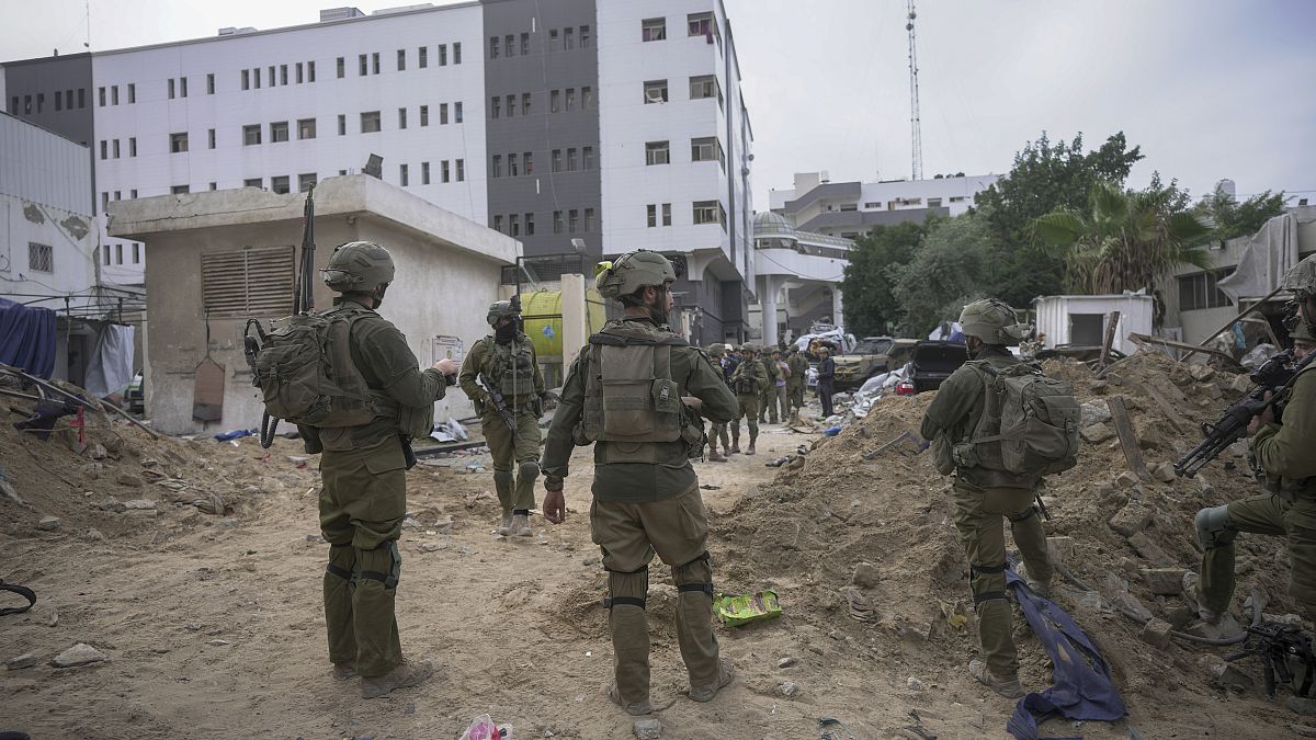 Israeli soldiers stand outside Shifa Hospital in Gaza City.