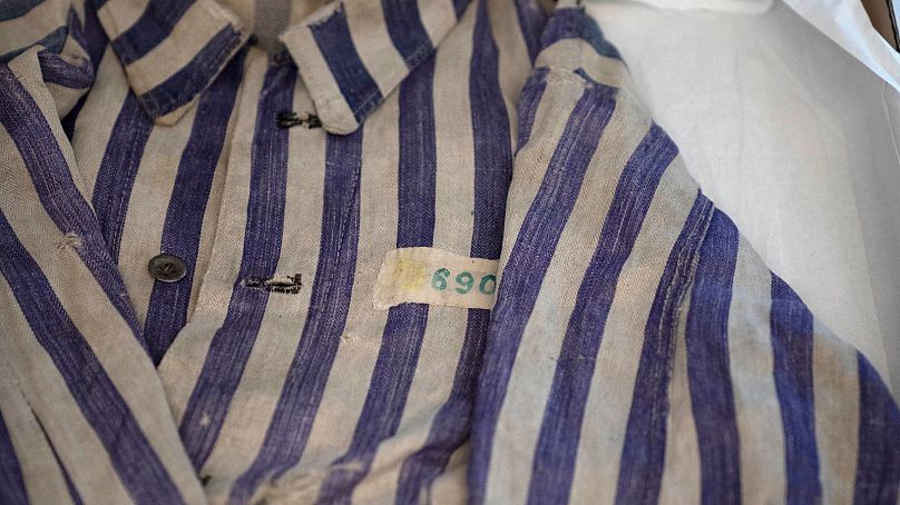 A striped uniform worn by a concentration camp prisoner is displayed in a textiles conservation lab during the inauguration of The Moshal Shoah Legacy Campus 