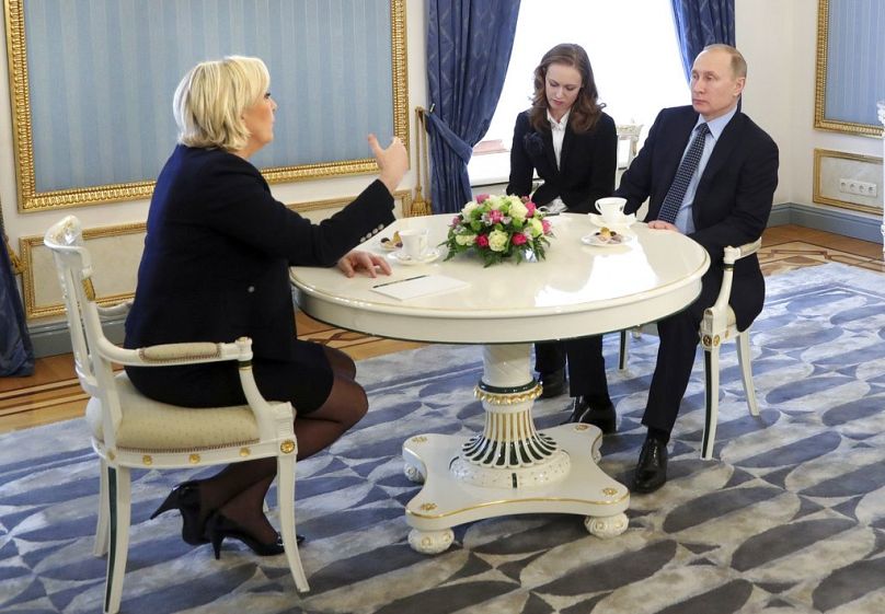 French far-right presidential candidate Marine Le Pen gestures while speaking to Russian President Vladimir Putin during their meeting in the Kremlin, 24 March 2017