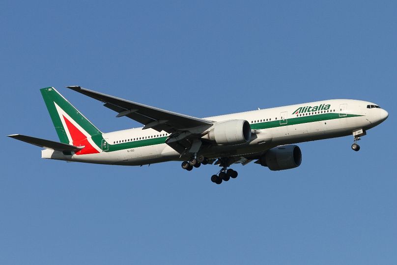 An Alitalia Boeing 777-200ER lands on the runway at Milan Malpensa Airport