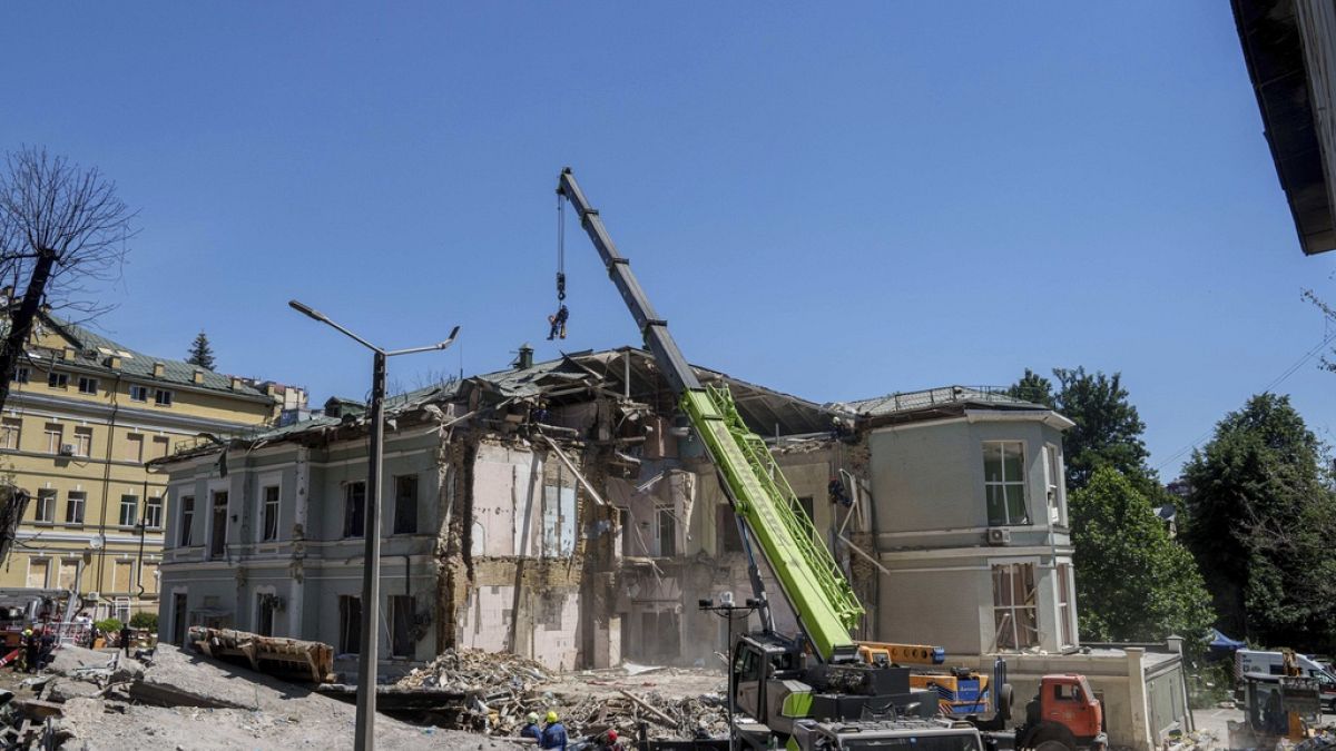 Rescue workers clear the rubble at the site of Okhmatdyt children's hospital hit by Russian missiles on Monday.