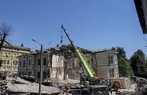 Rescue workers clear the rubble at the site of Okhmatdyt children's hospital hit by Russian missiles on Monday.