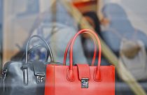 Women shop for bags in a luxurious outlet mall in London, Friday, Oct. 21, 2016. 