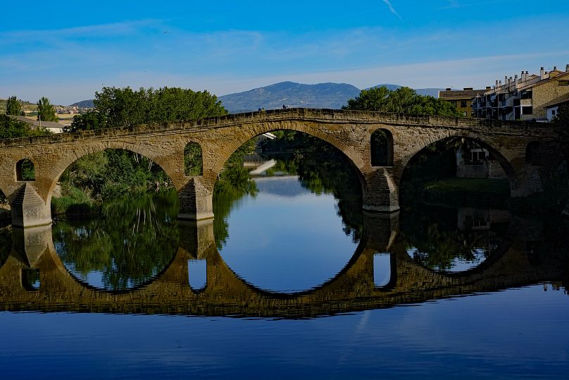 Pilgrims cross a bridge during a stage of 'Camino de Santiago' or St James Way, in Puente La Reina, northern Spain.