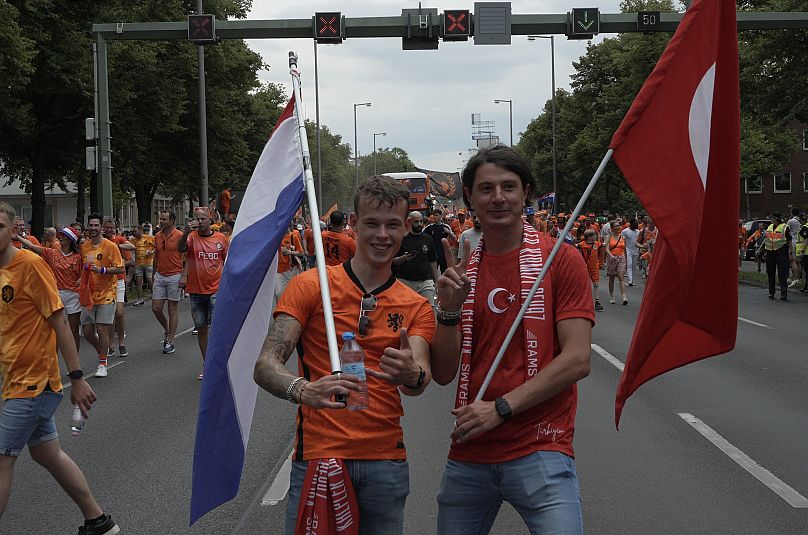 A Dutch and a Turkish fan at the Dutch fan walk in Berlin.
