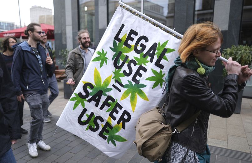 A person holds a banner during a demonstration in favour of the complete legalisation of cannabis, in Leipzig, Germany in April