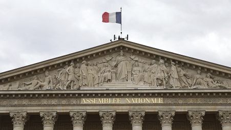 The French flag flies atop the National Assembly during the second round of the legislative elections, Sunday, July 7, 2024 in Paris